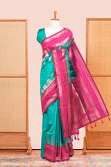 Rama Green Semi Art Silk Saree Delicate Golden Zari Motifs Along With Thalampoo Zari Woven Across The Body. The Border Is Broad With Intricate Floral Zari Weaving Rich Golden Zari Pallu