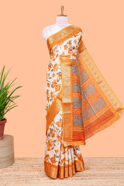 Cream floral design semi dola silk saree with contrast orange zari border an blouse