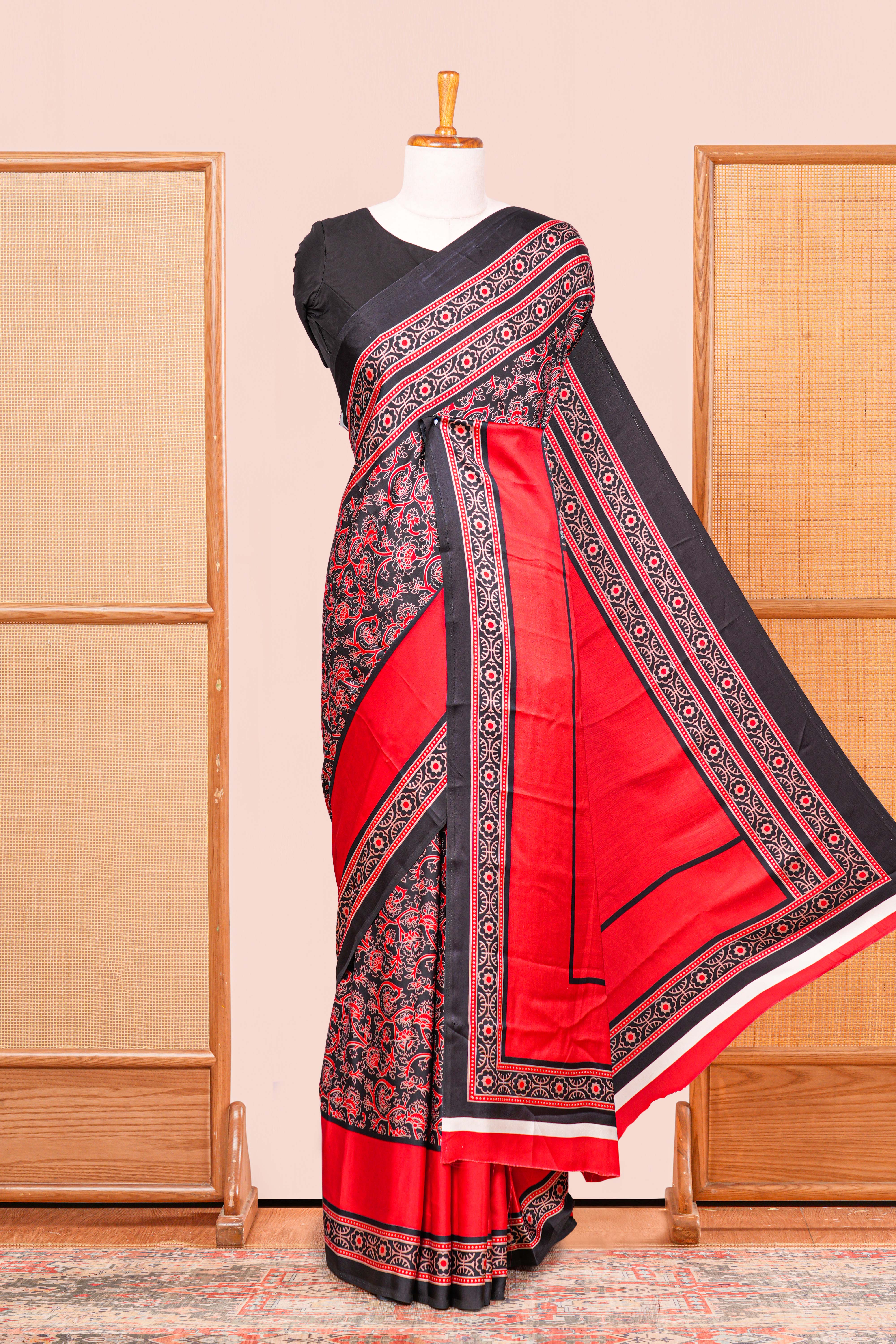 Black Modal Silk Saree The Body Has Ajrakh Design The Pallu Are Highlighted Vibrant Red Colour Along With Blouse