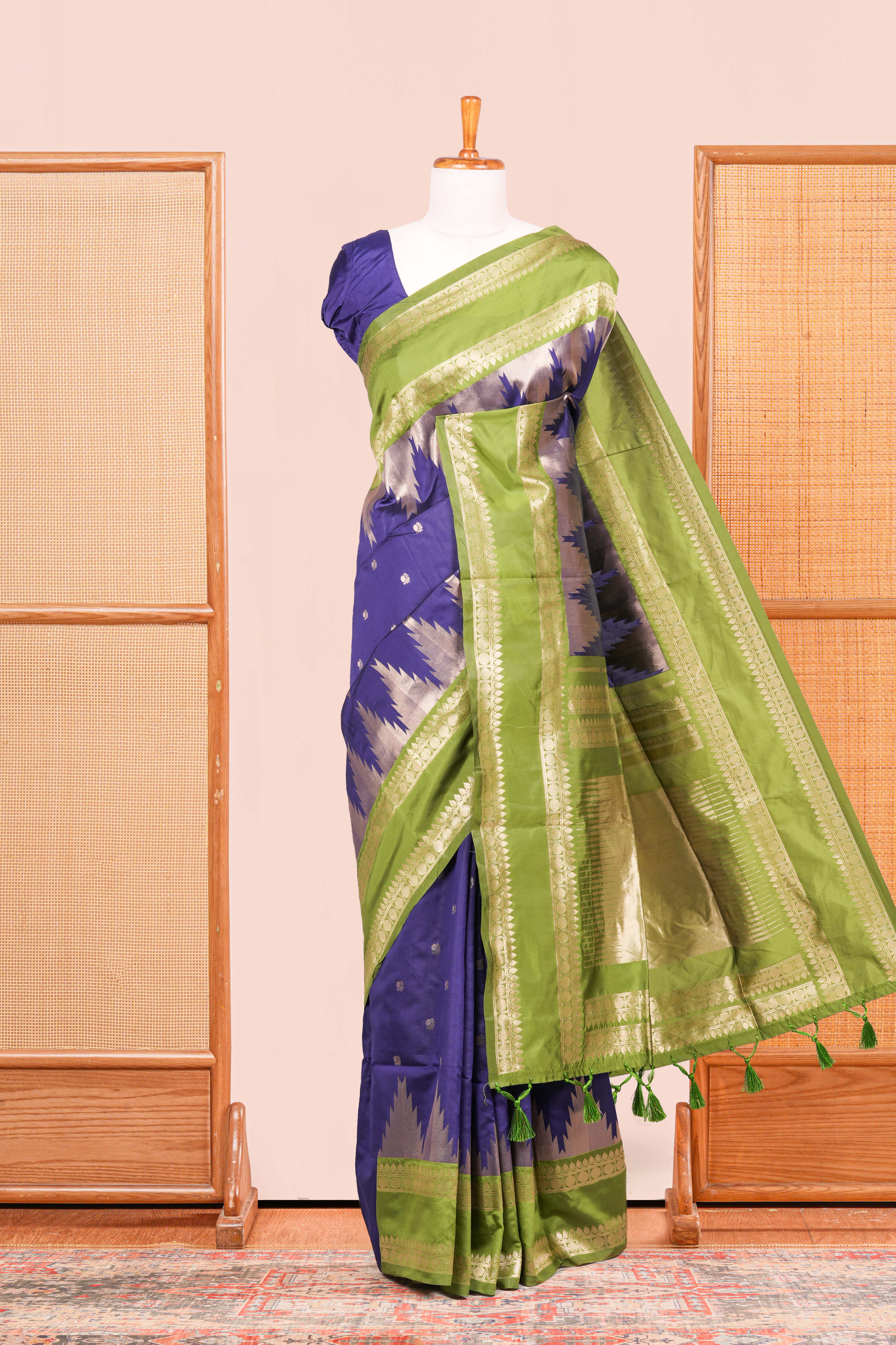 Blue Semi Art Silk Saree Delicate Golden Zari Motifs Along With Thalampoo Zari Woven Across The Body. The Border Is Broad With Intricate FloralZari Weaving Rich Golden Zari Pallu