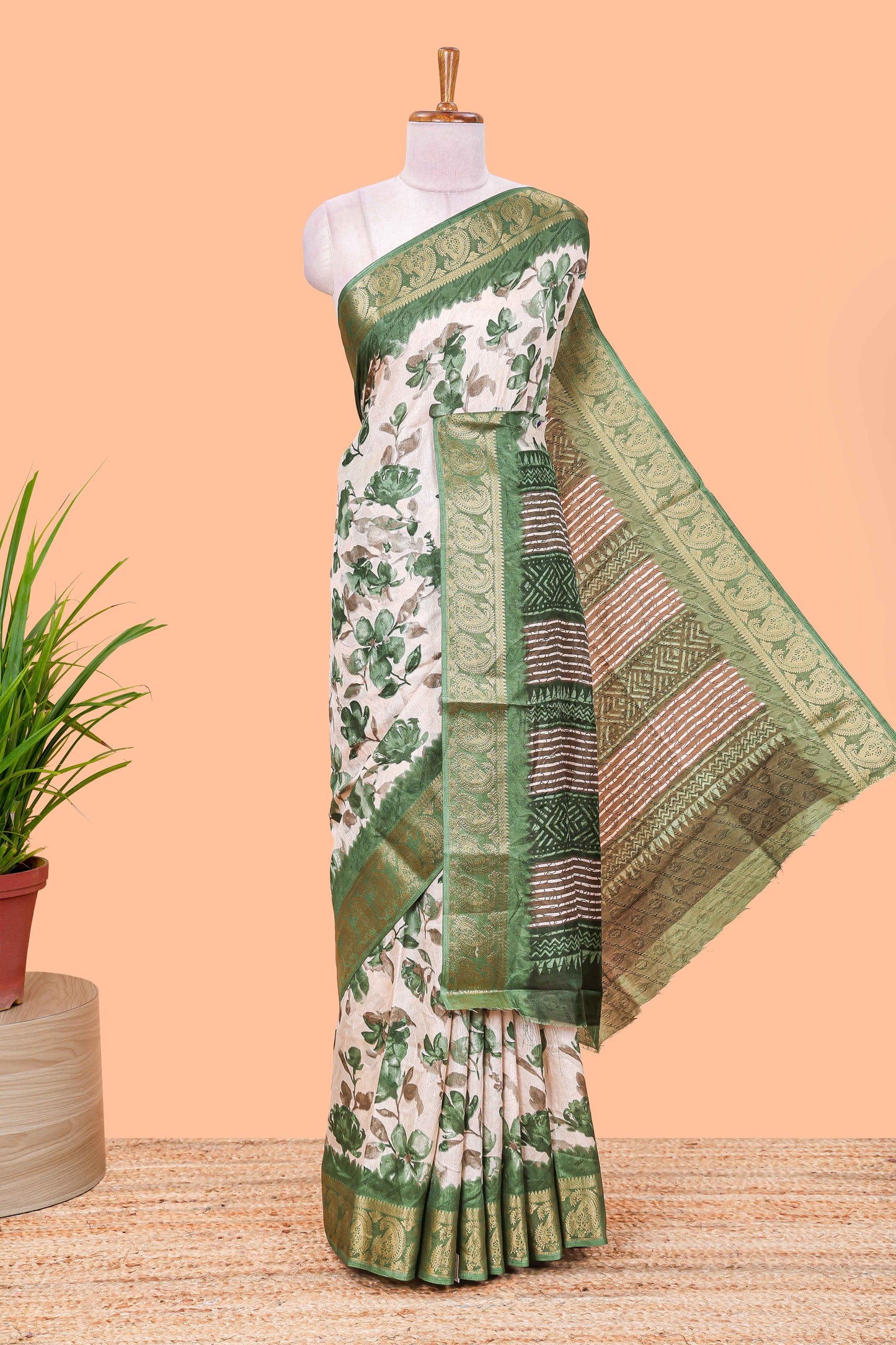 Cream floral design semi dola silk saree with contrast green zari border an blouse