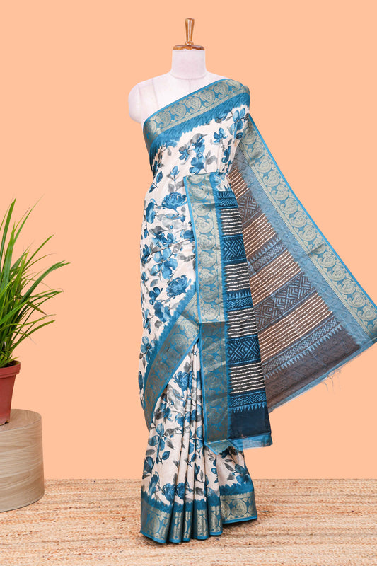 Cream floral design semi dola silk saree with contrast blue zari border an blouse