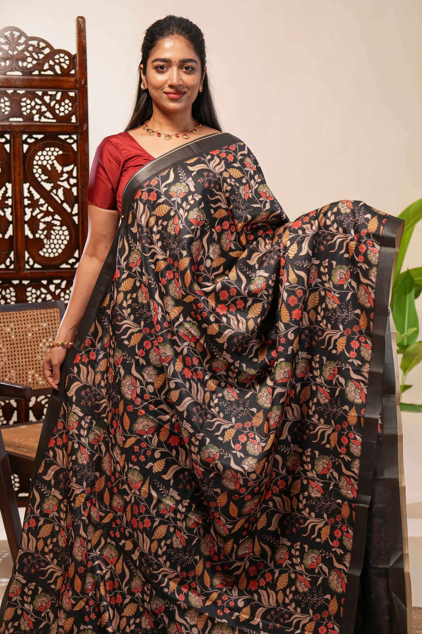 Black floral design tussar saree with self zari border and matching blouse