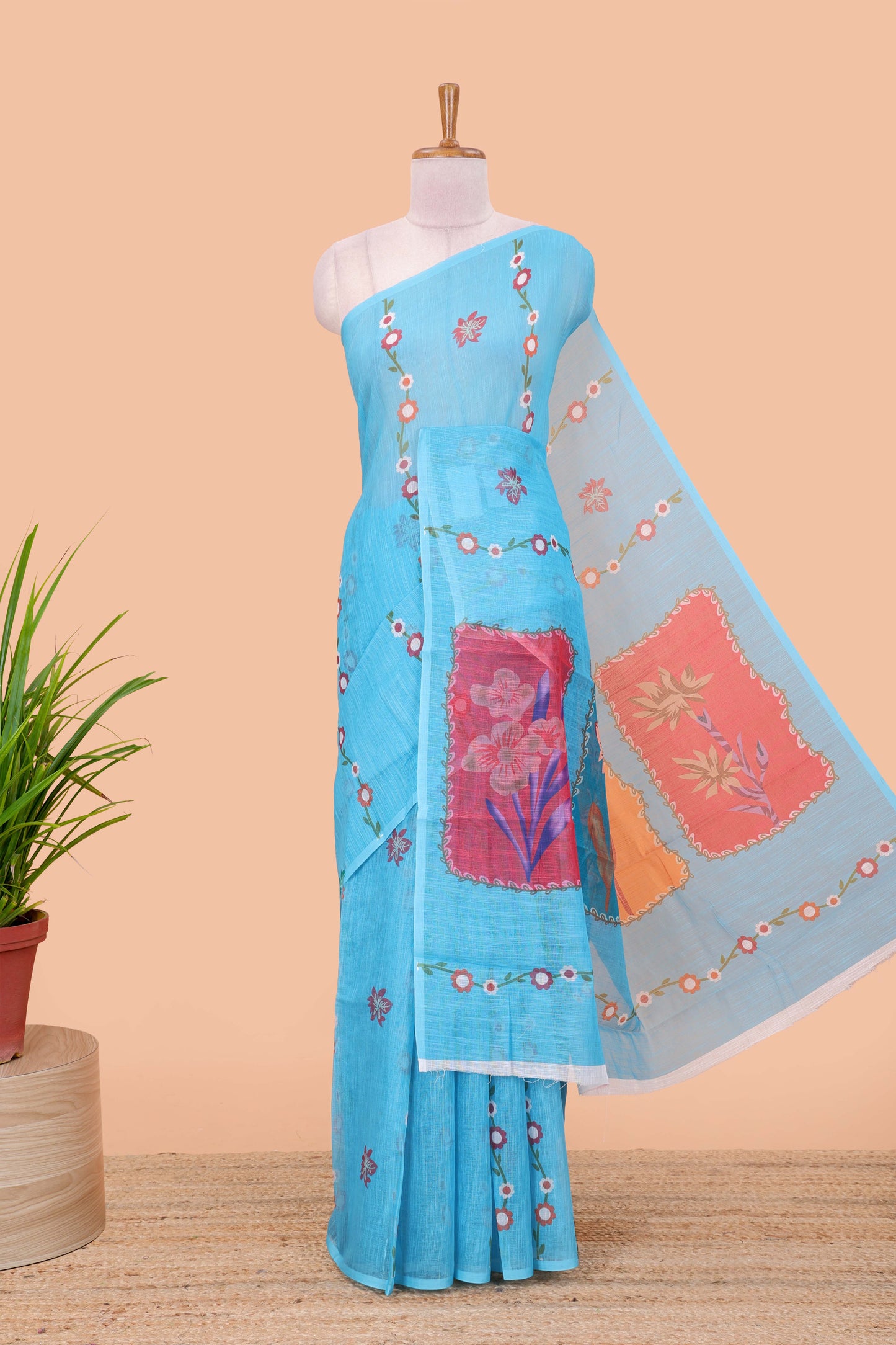 Borderless blue linen saree with floral design, printed pallu and blouse