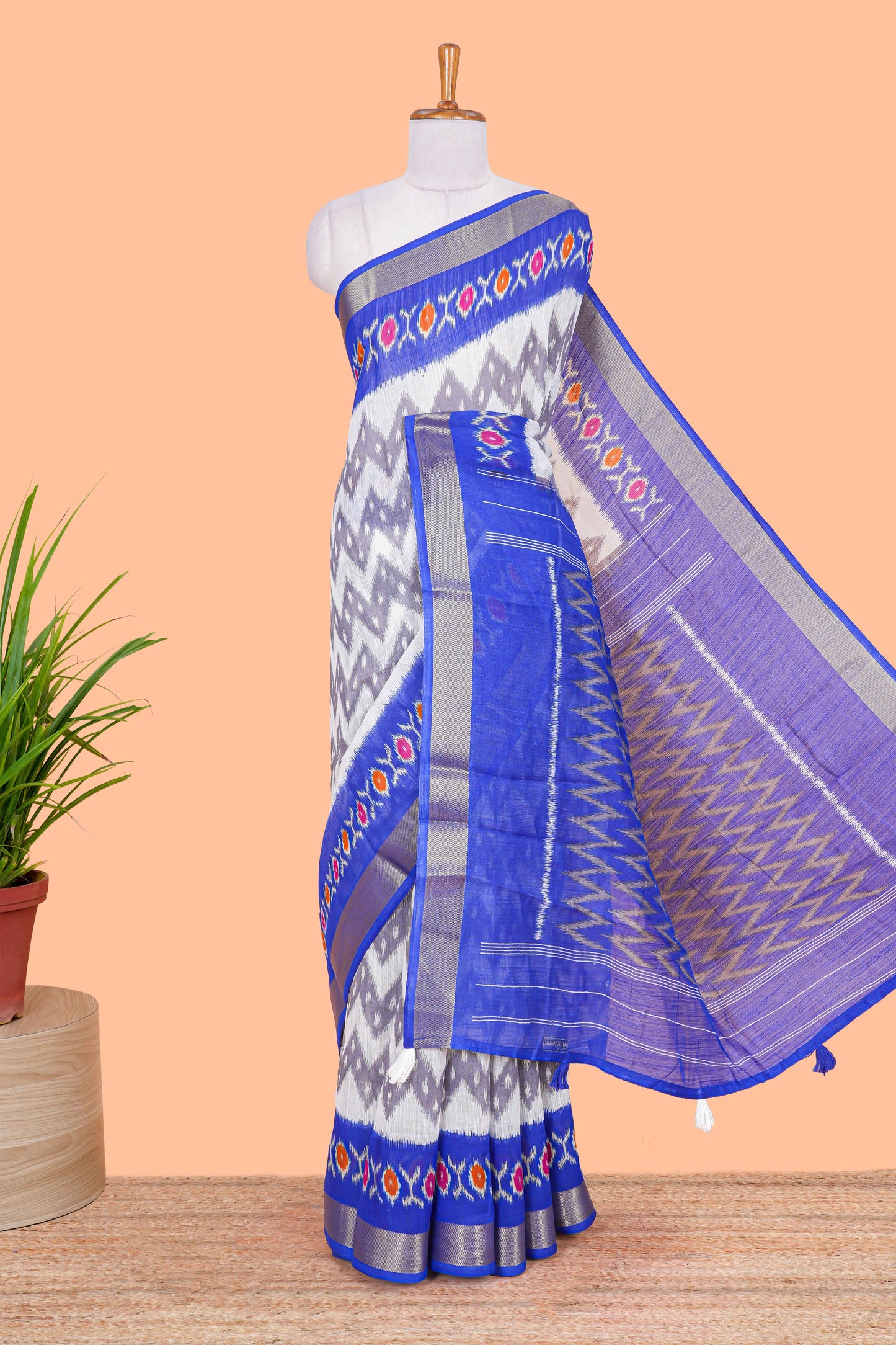 Off white geomentric ikkat style linen cotton saree with contrast border and pallu