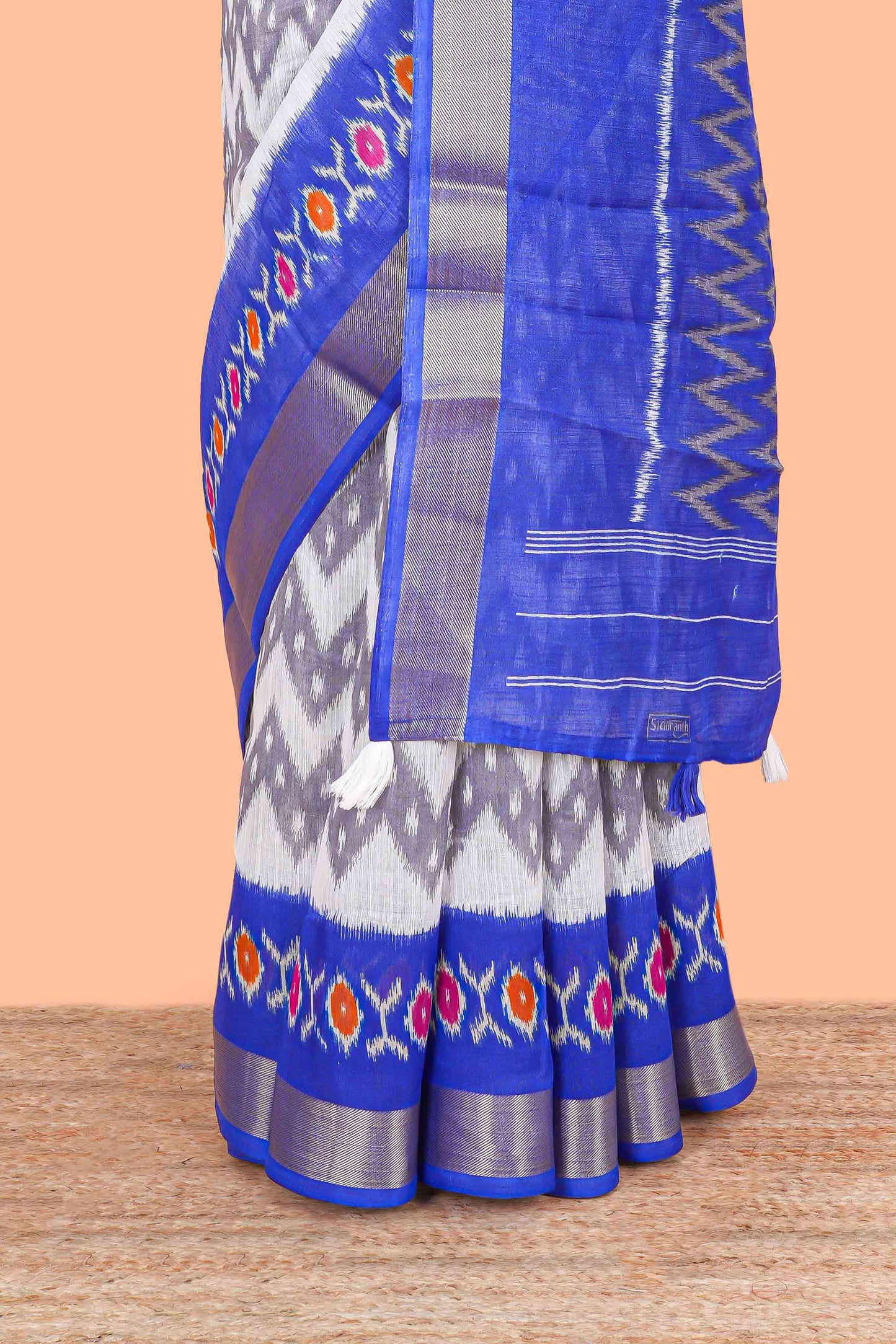 Off white geomentric ikkat style linen cotton saree with contrast border and pallu