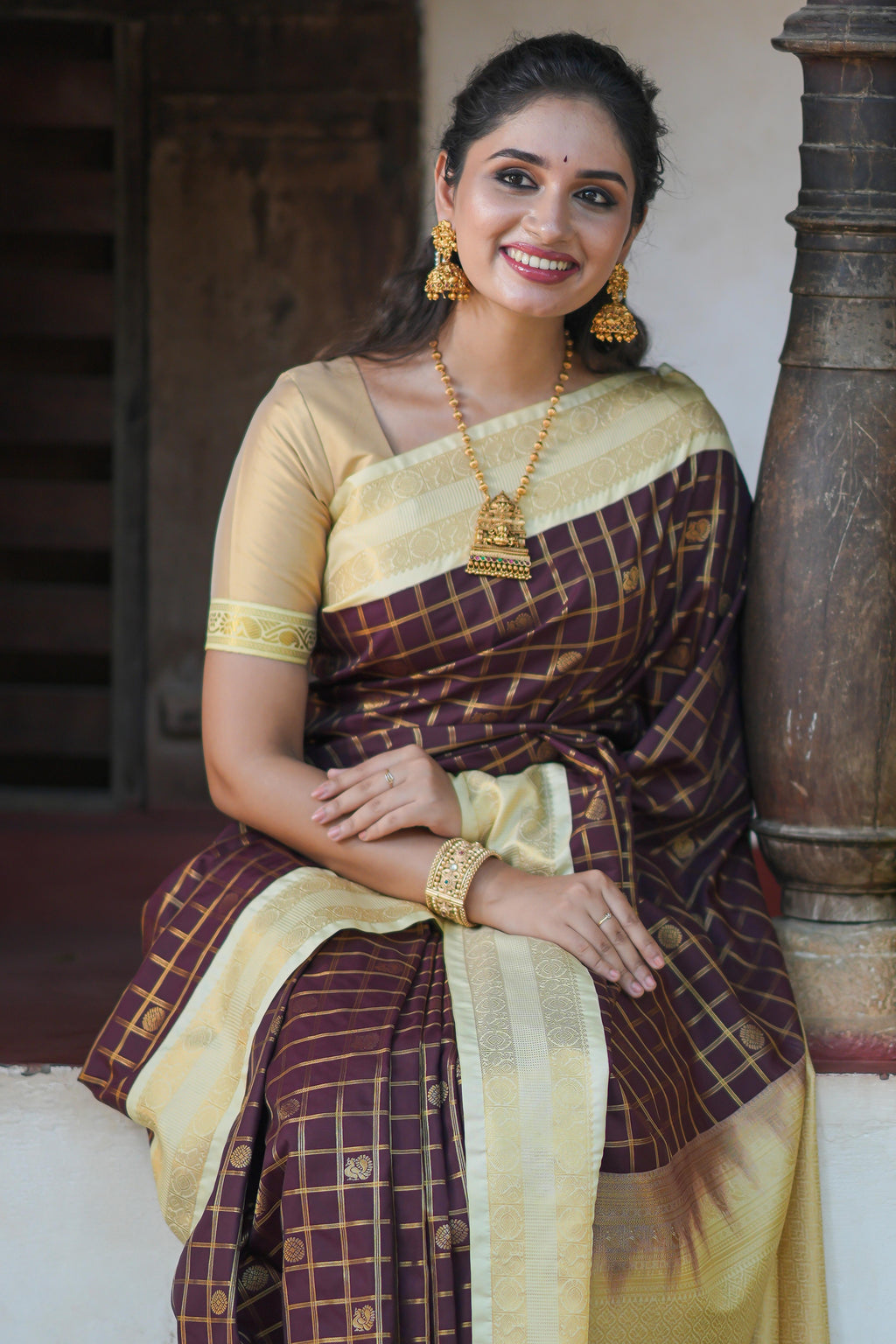 Brown checked art silk saree with contrast zari border and blouse