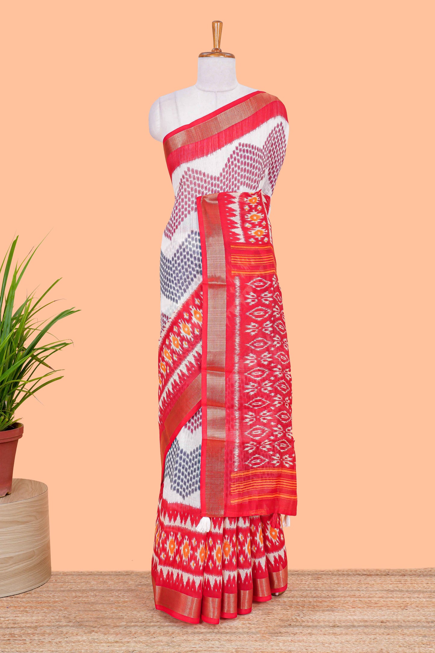 White geomentric ikkat style linen cotton saree with contrast orange border and pallu