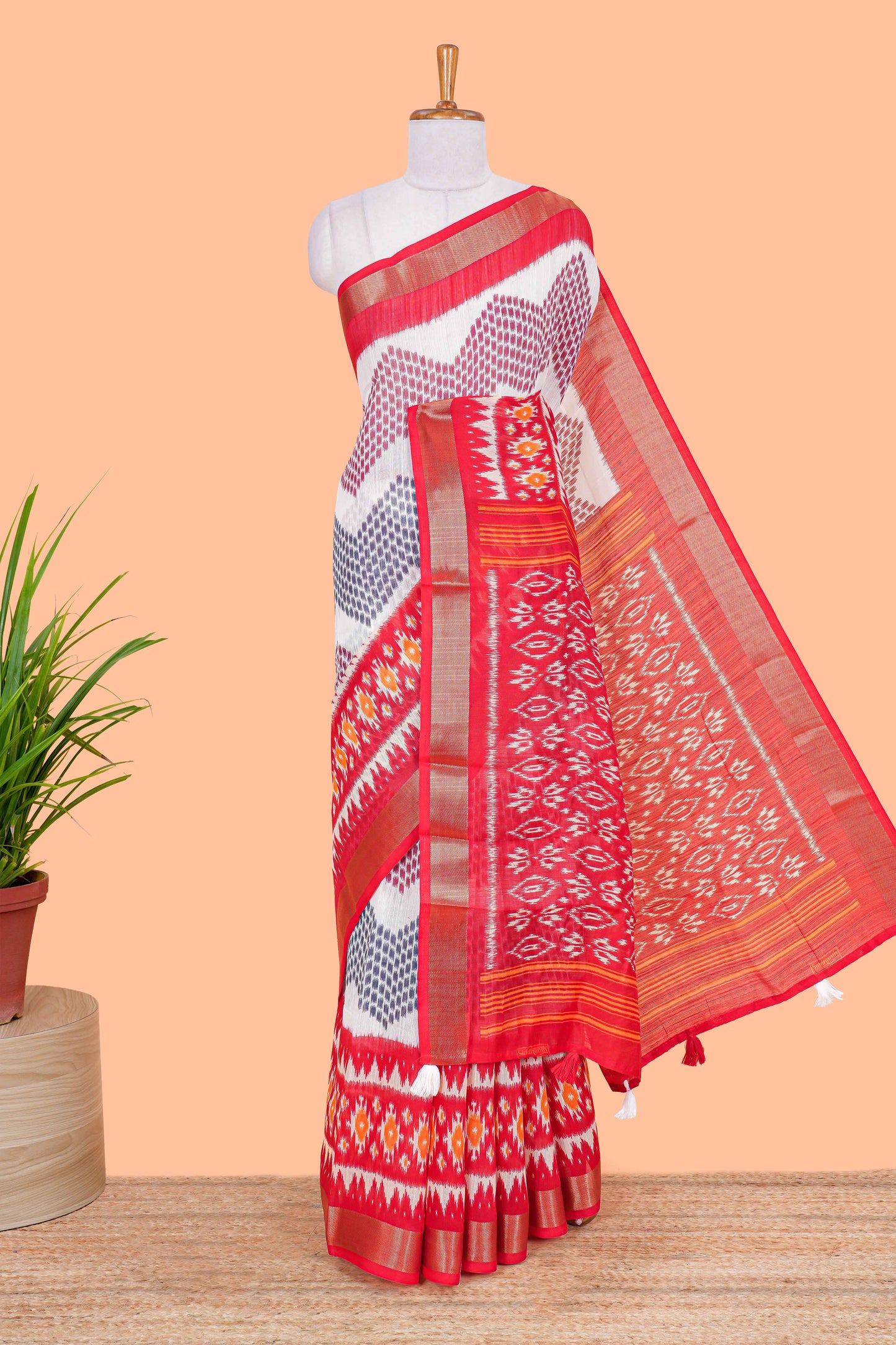White geomentric ikkat style linen cotton saree with contrast orange border and pallu