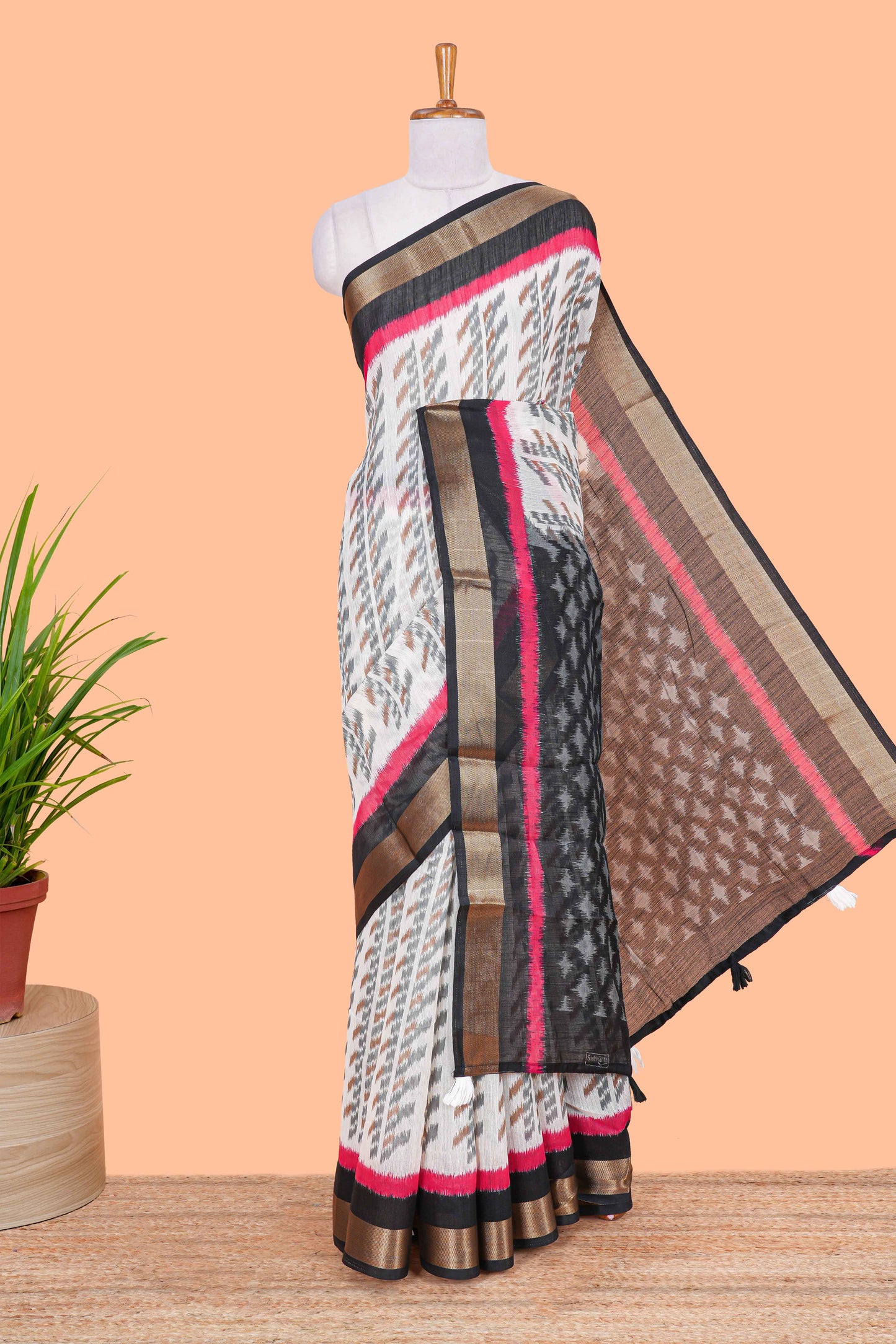 White geomentric ikkat style linen cotton saree with contrast black border and pallu