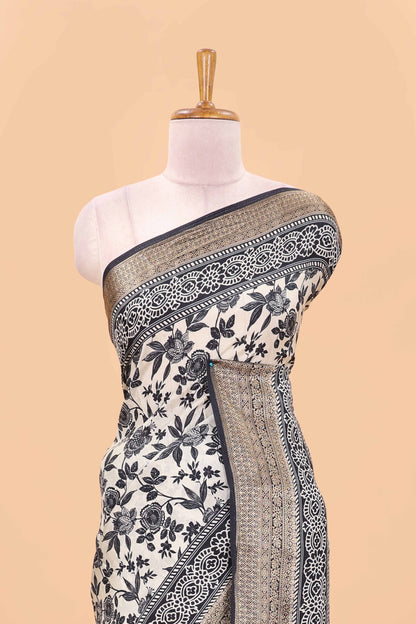 Cream assam silk saree with all over floral vines, contrast geomentric border and striped pallu