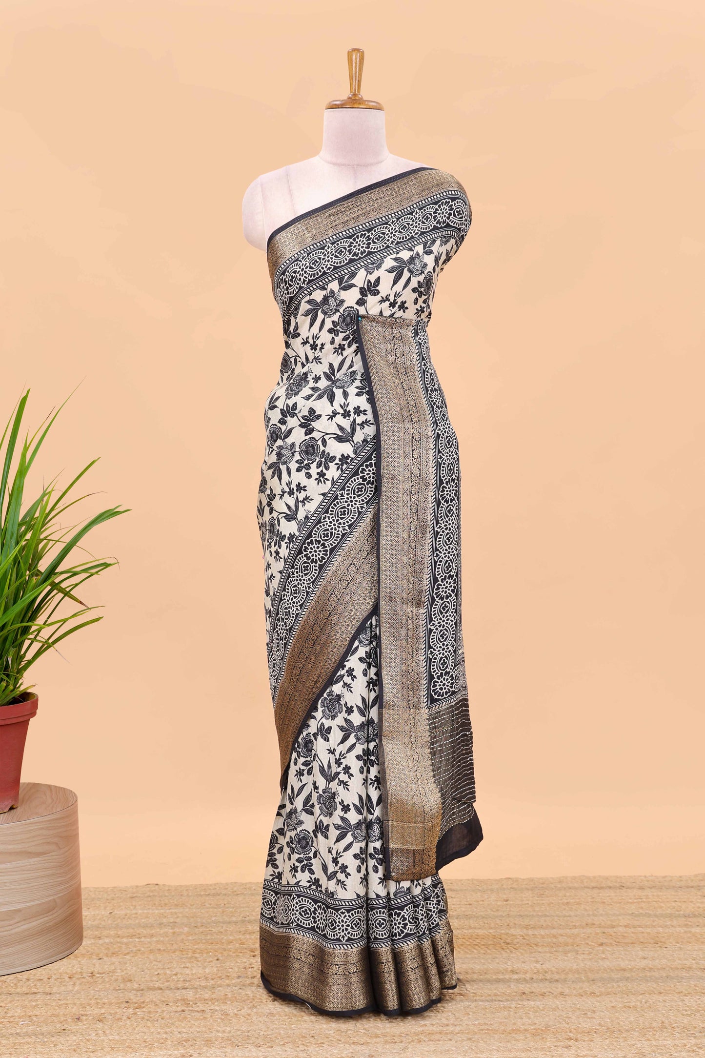 Cream assam silk saree with all over floral vines, contrast geomentric border and striped pallu