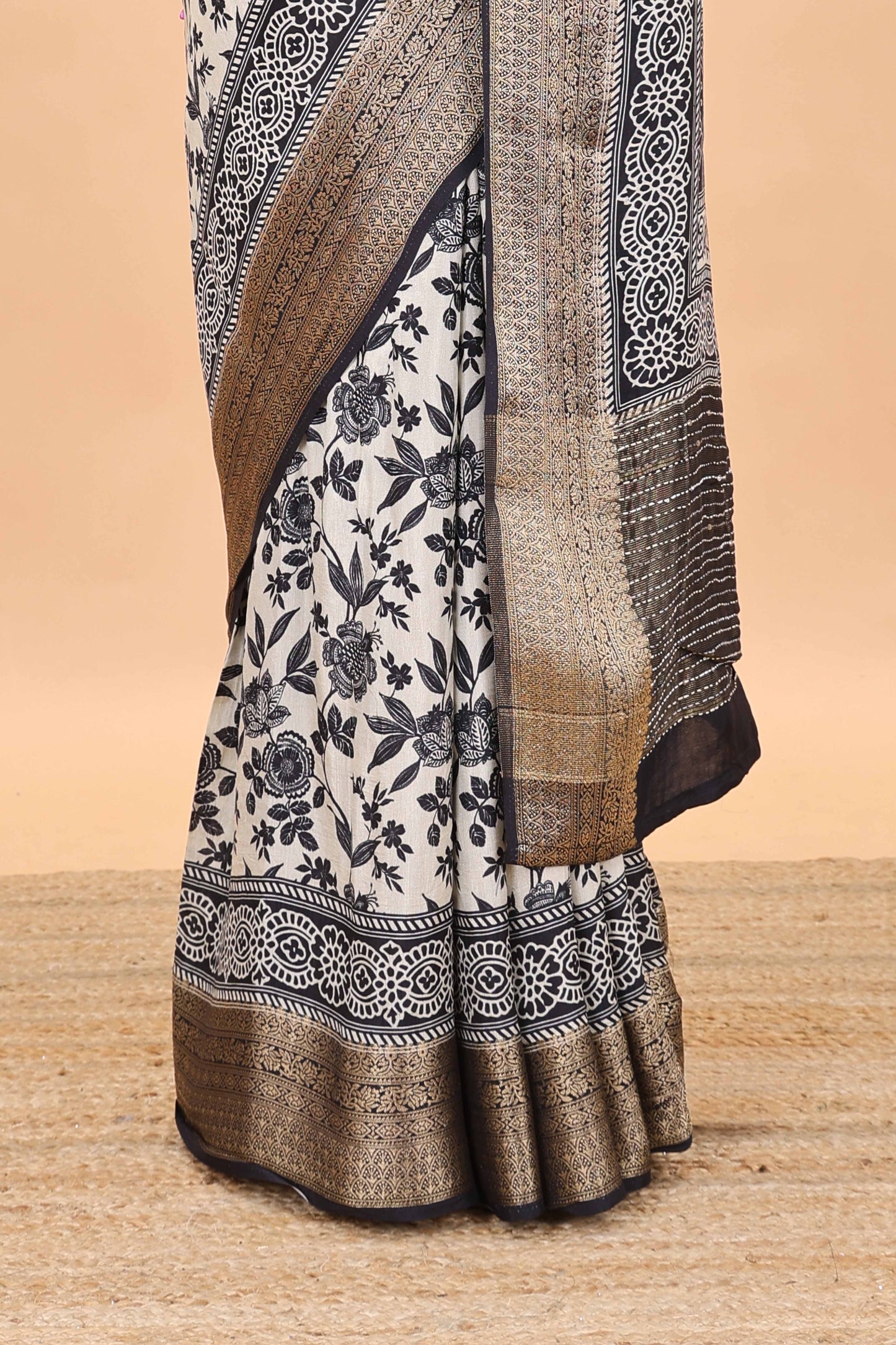Cream assam silk saree with all over floral vines, contrast geomentric border and striped pallu