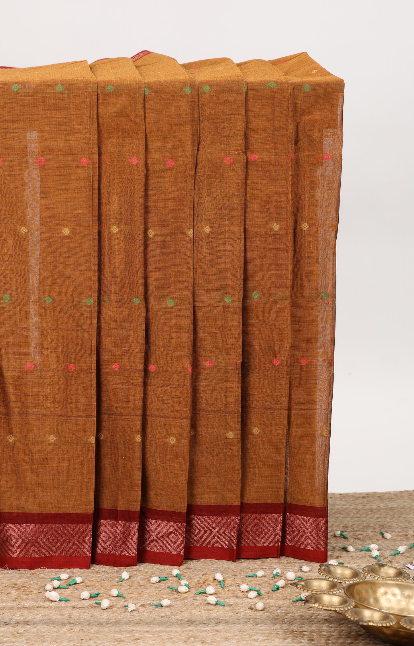 Bronze color small butta bengal cotton saree with contrast zari border and striped pallu