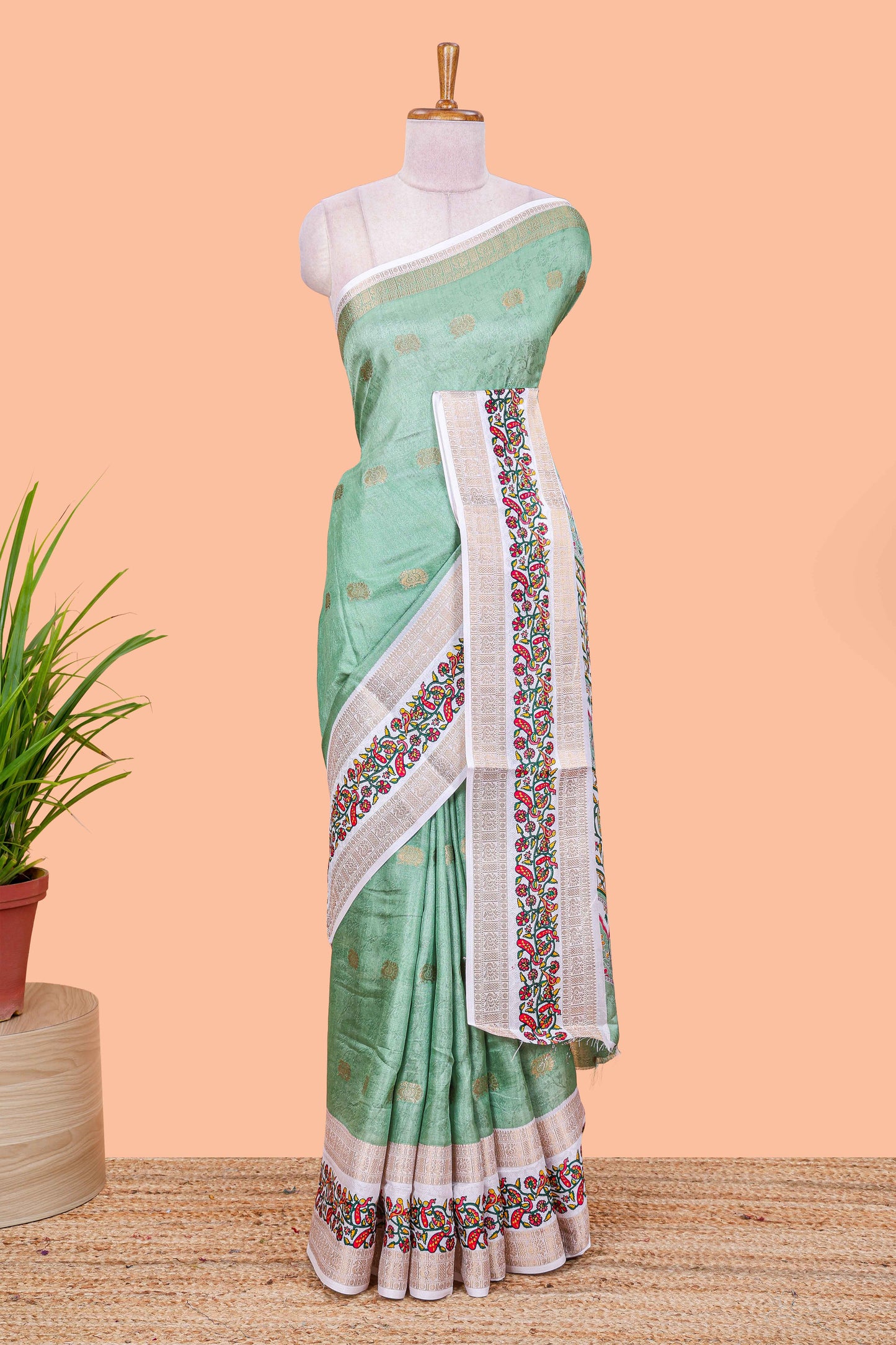 Green peacock zari butta dola silk saree with contrast floral vine border and printed blouse