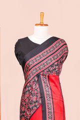 Black Modal Silk Saree The Body Has Ajrakh Design The Pallu Are Highlighted Vibrant Red Colour Along With Blouse