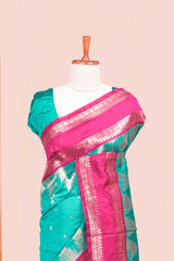 Rama Green Semi Art Silk Saree Delicate Golden Zari Motifs Along With Thalampoo Zari Woven Across The Body. The Border Is Broad With Intricate Floral Zari Weaving Rich Golden Zari Pallu