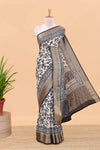 Cream assam silk saree with all over floral print, contrast zari border and pallu