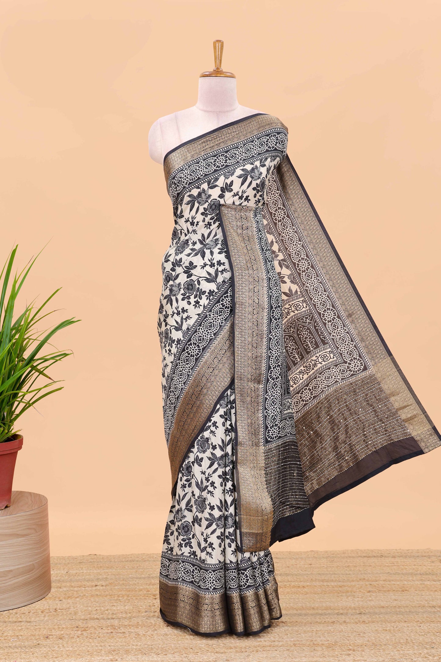Cream assam silk saree with all over floral vines, contrast geomentric border and striped pallu