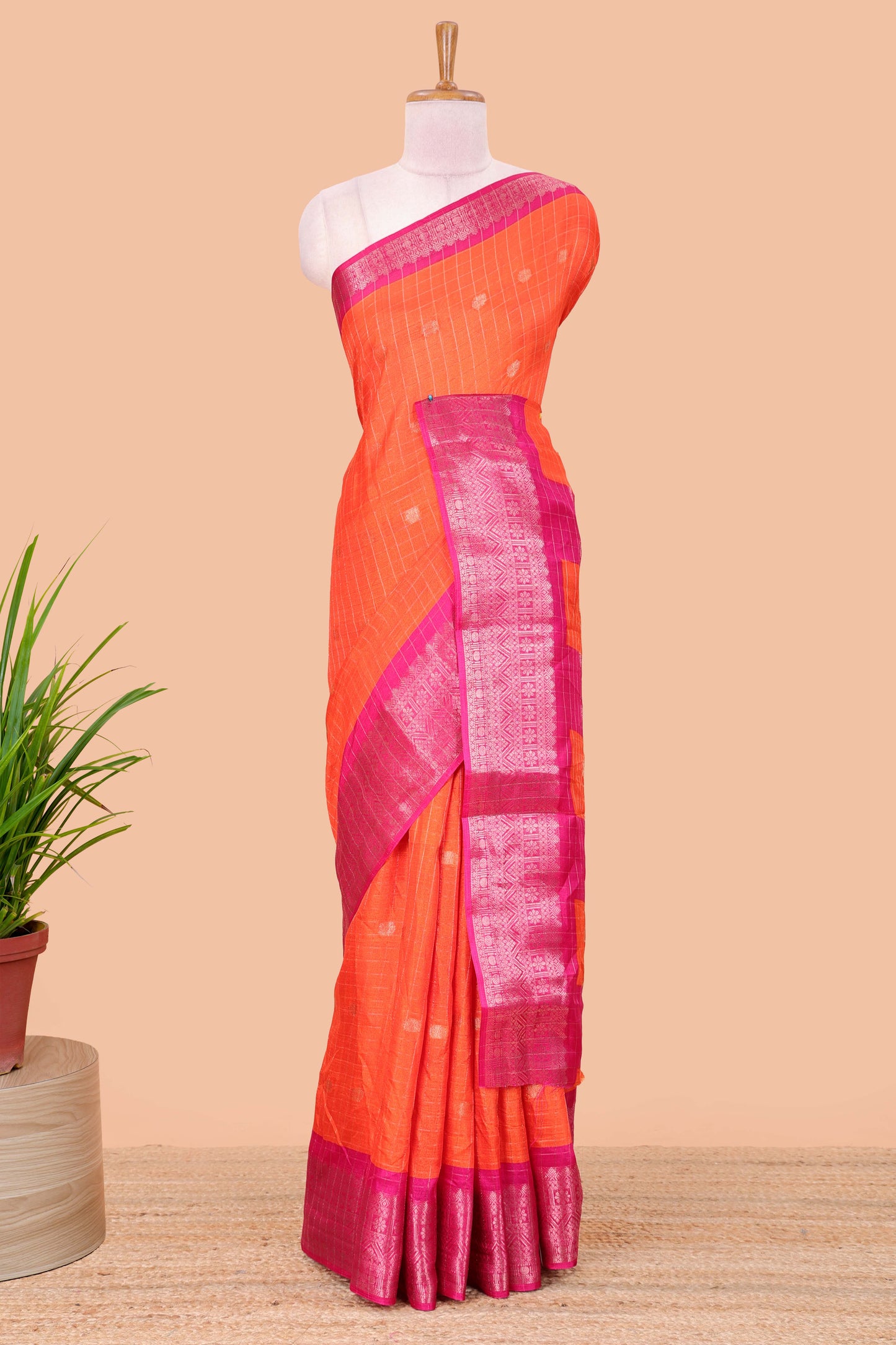Red viscose dola silk saree with all over checked butta design, contrast zari border and pallu
