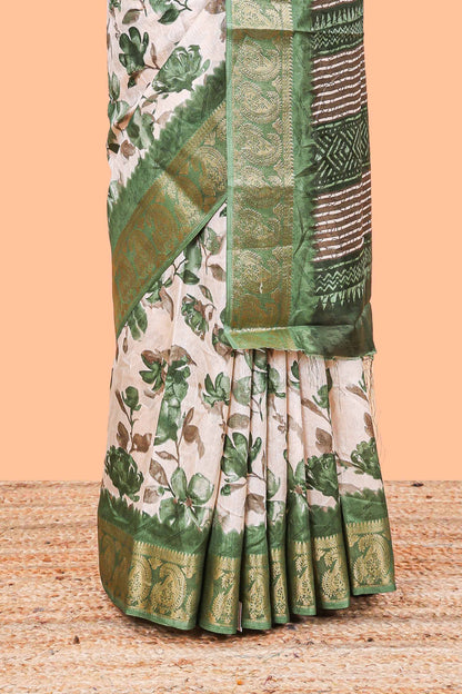 Cream floral design semi dola silk saree with contrast green zari border an blouse