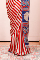 White Modal Silk Saree Body Detailing Contrast Red Vertical Stripes That Add a Sleek and Elegant Touch. The Pallu Are Highlighted Ajrakh Design Along With Blouse