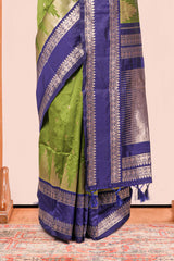 Green Semi Art Silk Saree Delicate Golden Zari Motifs Along With Thalampoo Zari Woven Across The Body. The Border Is Broad With Intricate Floral Zari Weaving Rich Golden Zari Pallu