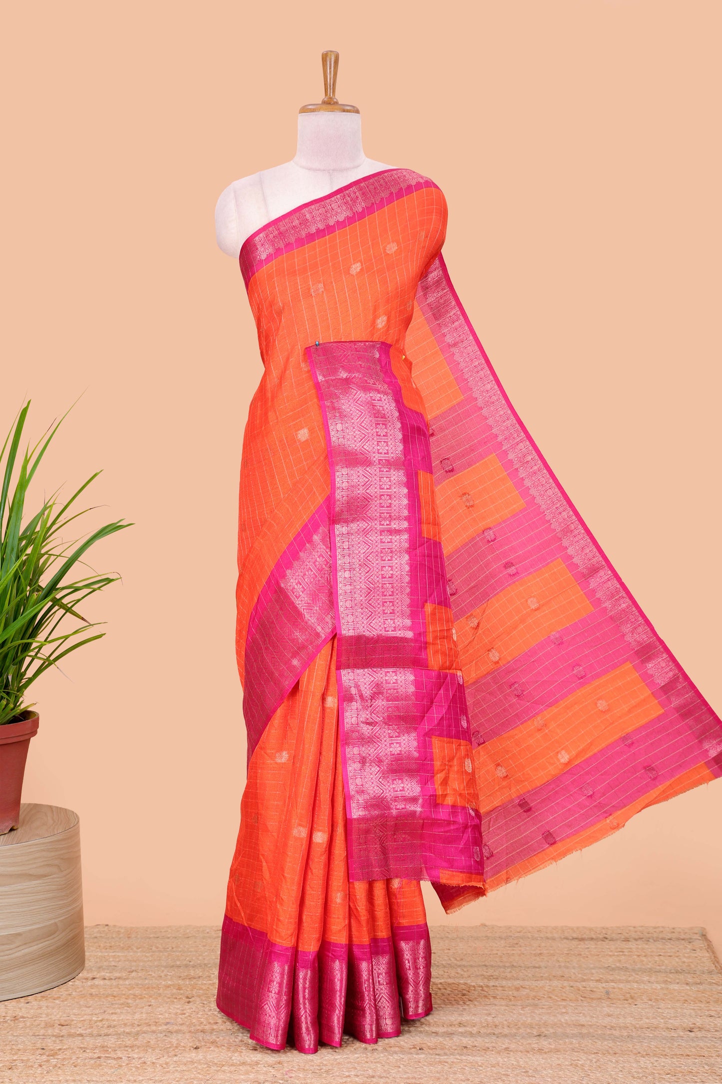 Red viscose dola silk saree with all over checked butta design, contrast zari border and pallu