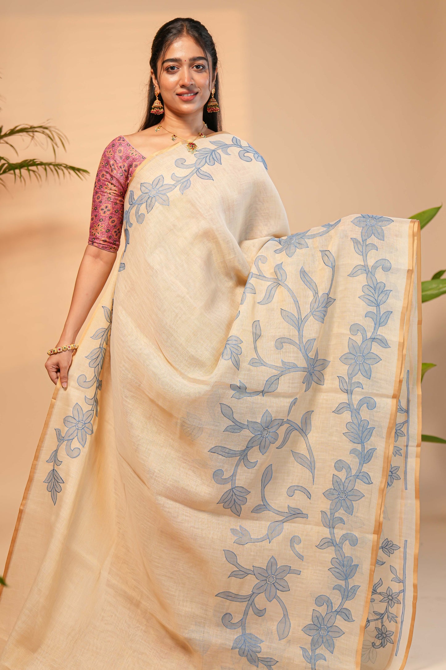 Cream floral design linen cotton saree with self zari border and matching printed blouse