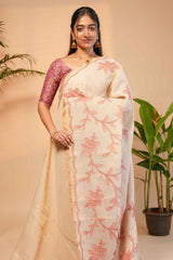 Cream floral design linen cotton saree with self zari border and contrast printed blouse