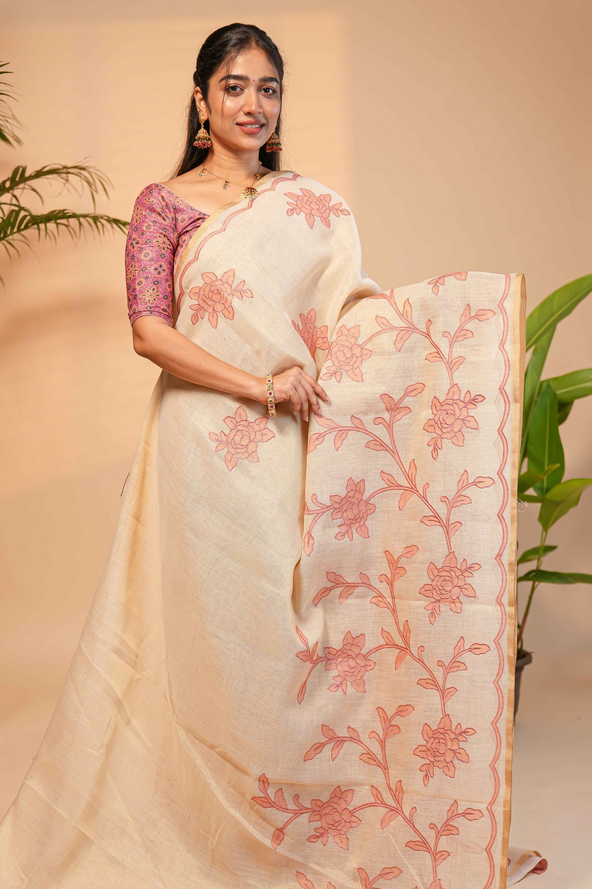 Cream floral design linen cotton saree with self zari border and contrast printed blouse