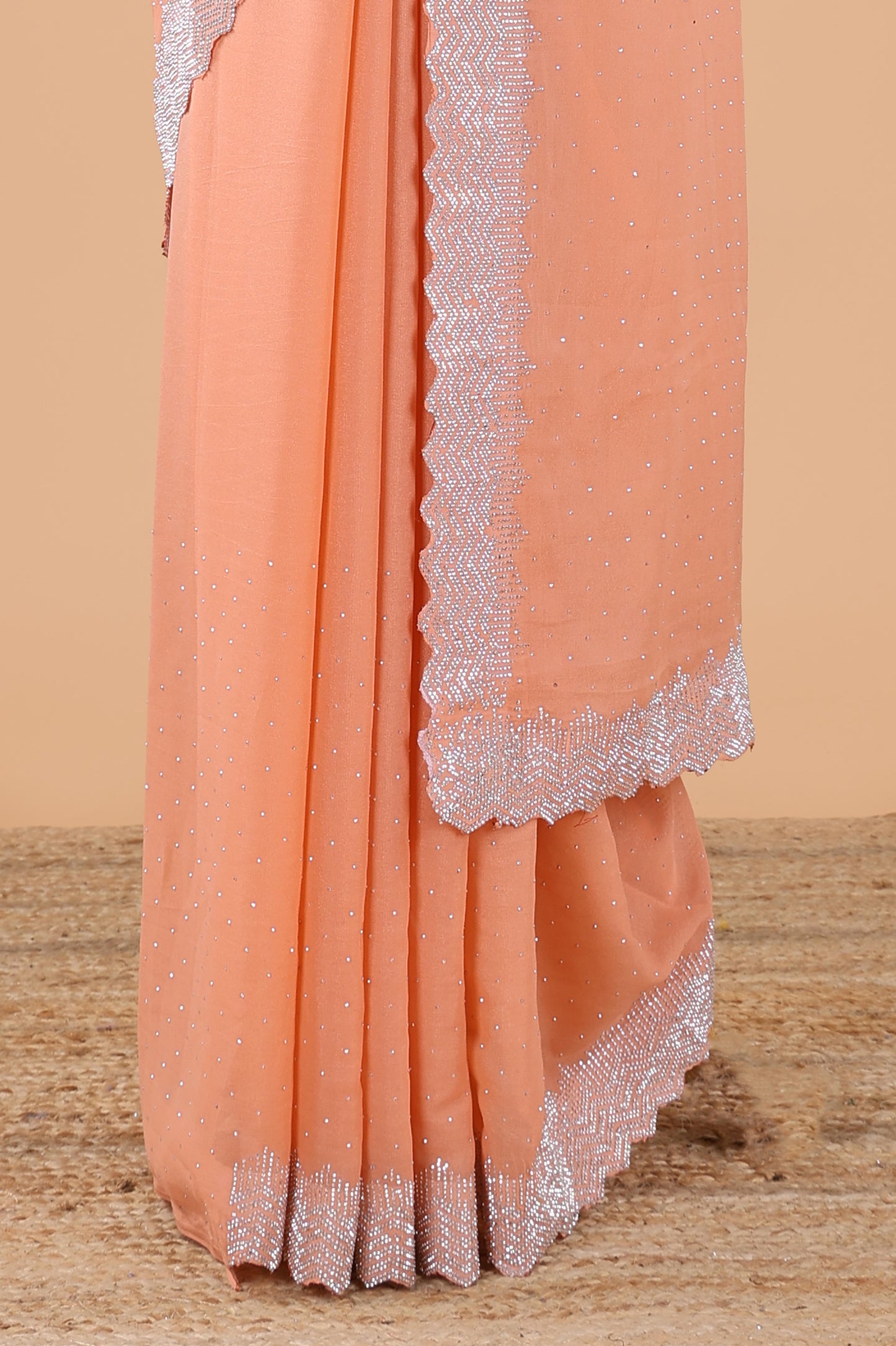 Orange designer georgette space silk saree with heavy stone & beads work, short pallu and contrast sequin embroidered blouse