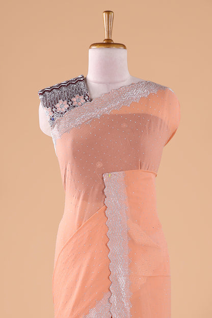 Orange designer georgette space silk saree with heavy stone & beads work, short pallu and contrast sequin embroidered blouse