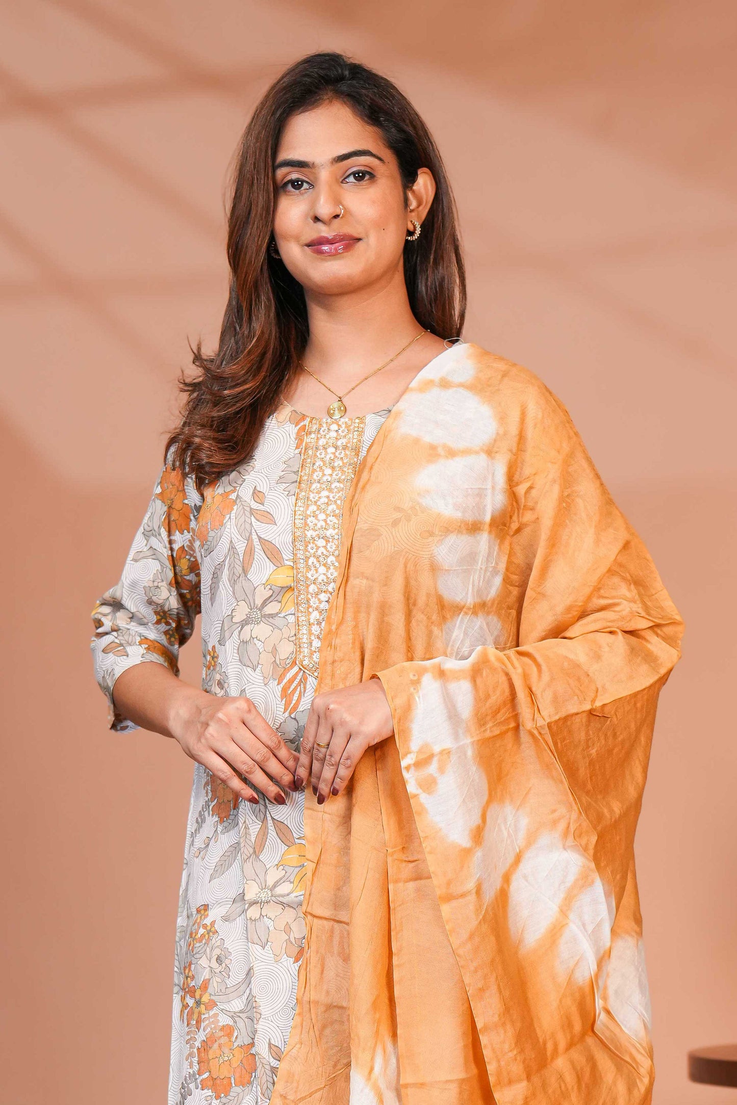 Orange floral design chamki work round neck salwar set with 3/4th sleeve, self bottom and matching dupatta