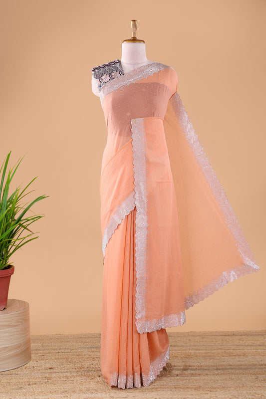 Orange designer georgette space silk saree with heavy stone & beads work, short pallu and contrast sequin embroidered blouse