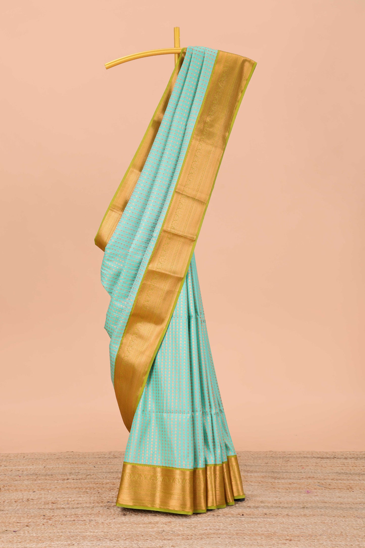 Green semi-soft silk saree featuring an all-over thousand butta design, paired with a contrasting border