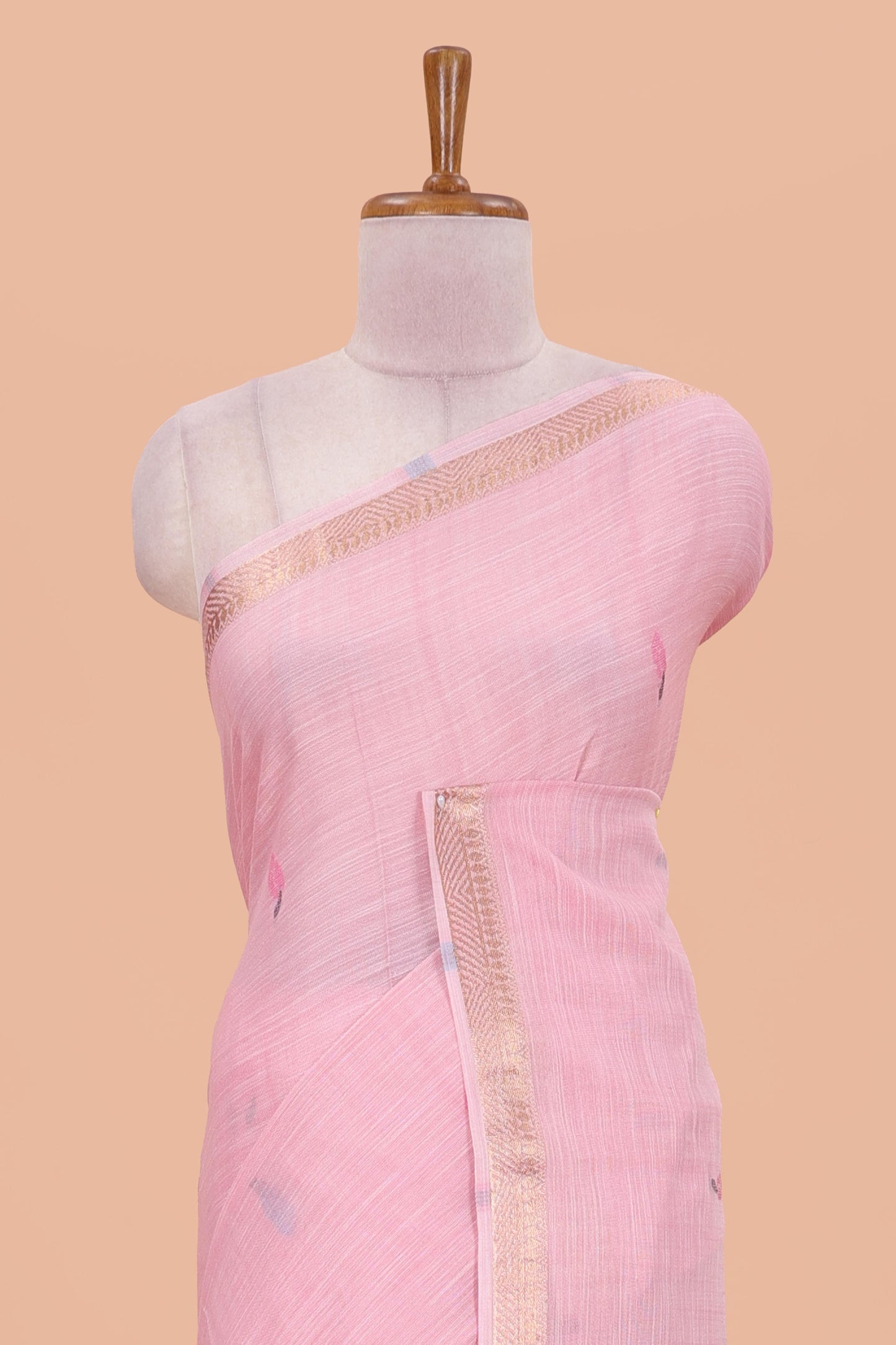 Pink linen cotton saree with buttas and floral design pallu, zari border