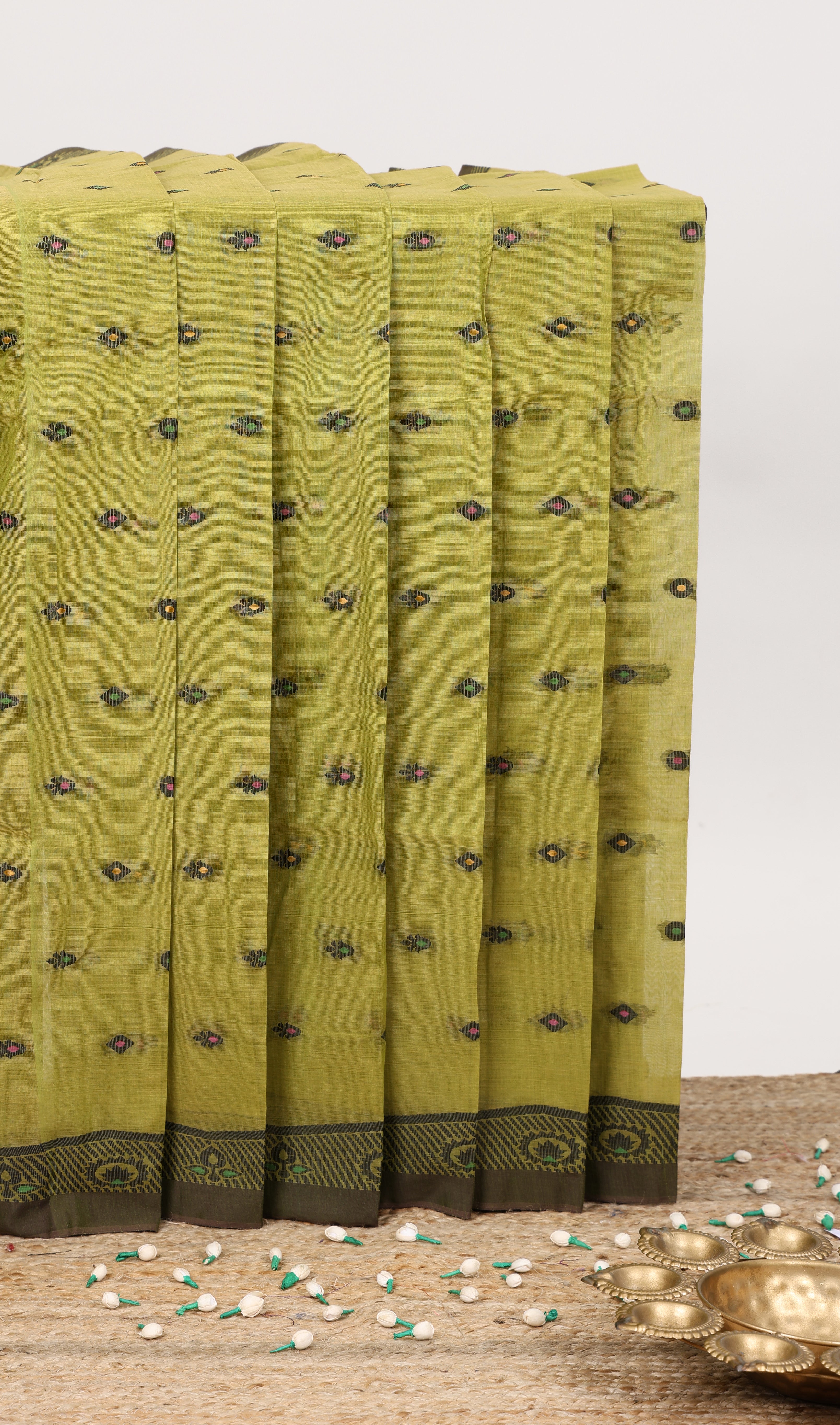 Green small butta bengal cotton saree with self border and floral design pallu