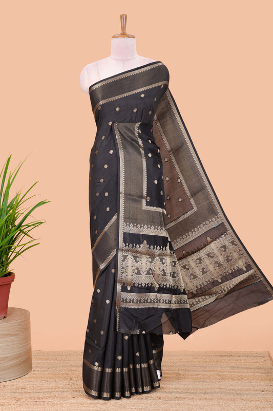 Black dola silk saree with all over zari butta, bendex zari border, rich zari pallu and contrast blouse