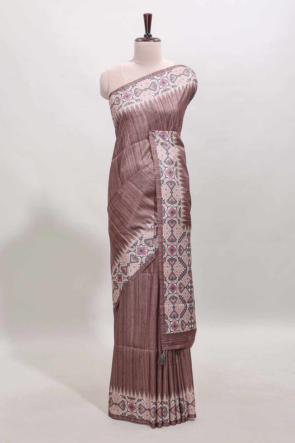 Tussar Silk Saree with a textured mauve body geometric woven border and a designer pallu with tassel along with blouse