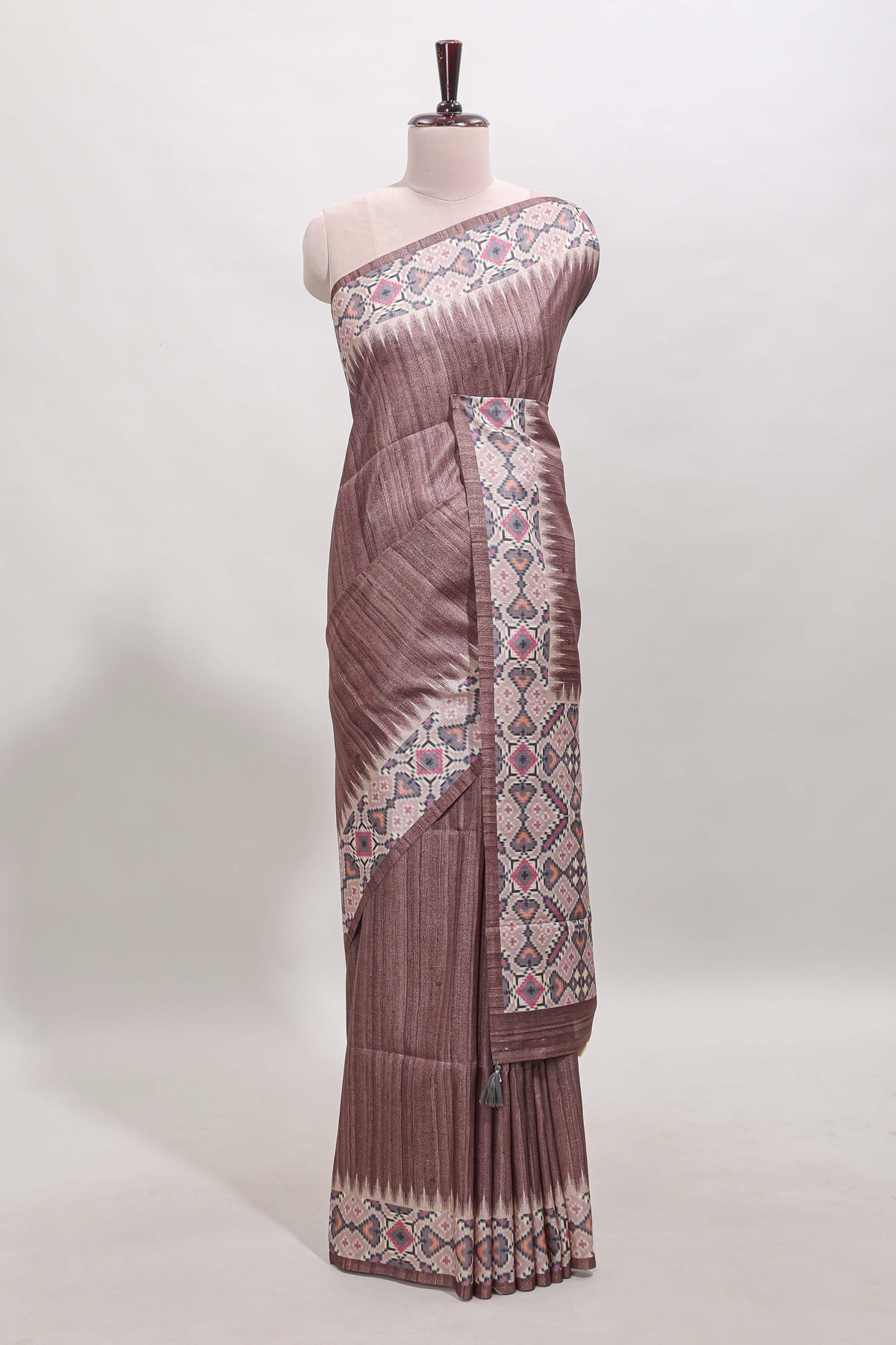 Tussar Silk Saree with a textured mauve body geometric woven border and a designer pallu with tassel along with blouse