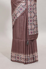 Tussar Silk Saree with a textured mauve body geometric woven border and a designer pallu with tassel along with blouse