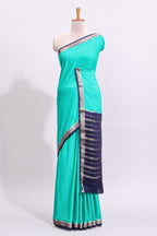 Green plain art mysore silk saree with contrast zari border and blouse