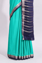 Green plain art mysore silk saree with contrast zari border and blouse
