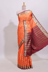 Bright orange jaal pattern with small floral motifs art mysore silk saree with contrast border and blouse