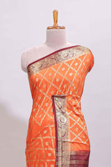 Bright orange jaal pattern with small floral motifs art mysore silk saree with contrast border and blouse