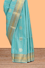 Turquoise green striped zari motifs art silk saree with self zari border and matching blouse