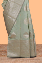 Pista green zari floral motifs art silk saree with self zari border and matching motifs blouse