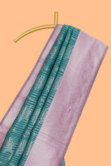 Teal green striped floral design art silk saree with contrast zari border and zari motifs blouse