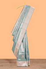 Green geometric floral design art silk saree with contrast zari border and motifs blouse
